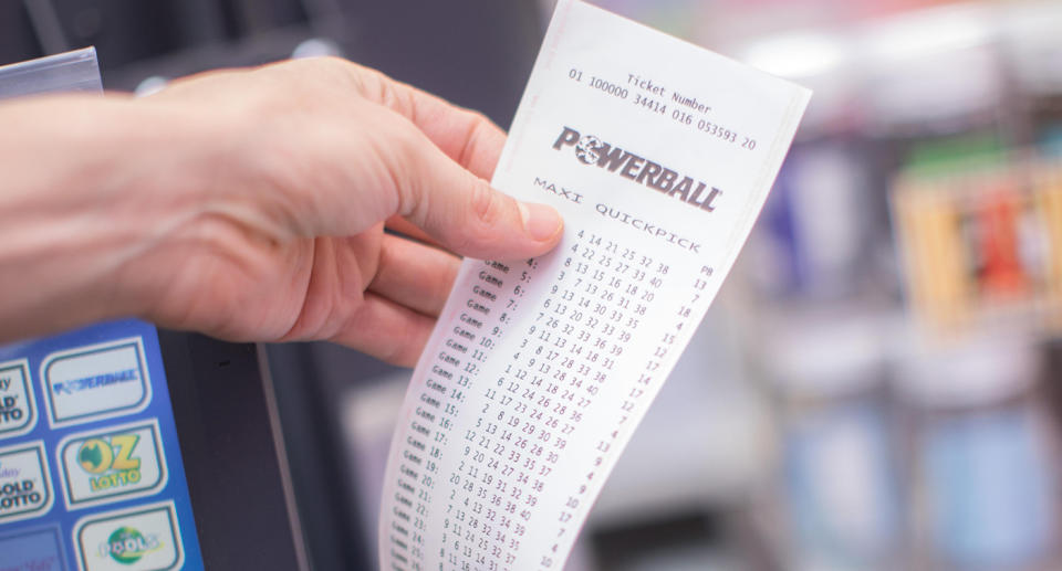 A Powerball ticket is printed out of a machine at a newsagency.