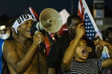 Anti-police demonstrators scream as they march in protest in Ferguson, Missouri August 10, 2015. REUTERS/Lucas Jackson