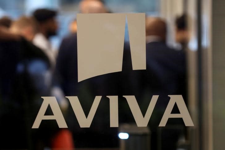 An Aviva logo sits on the window of the company head office in the city of London.