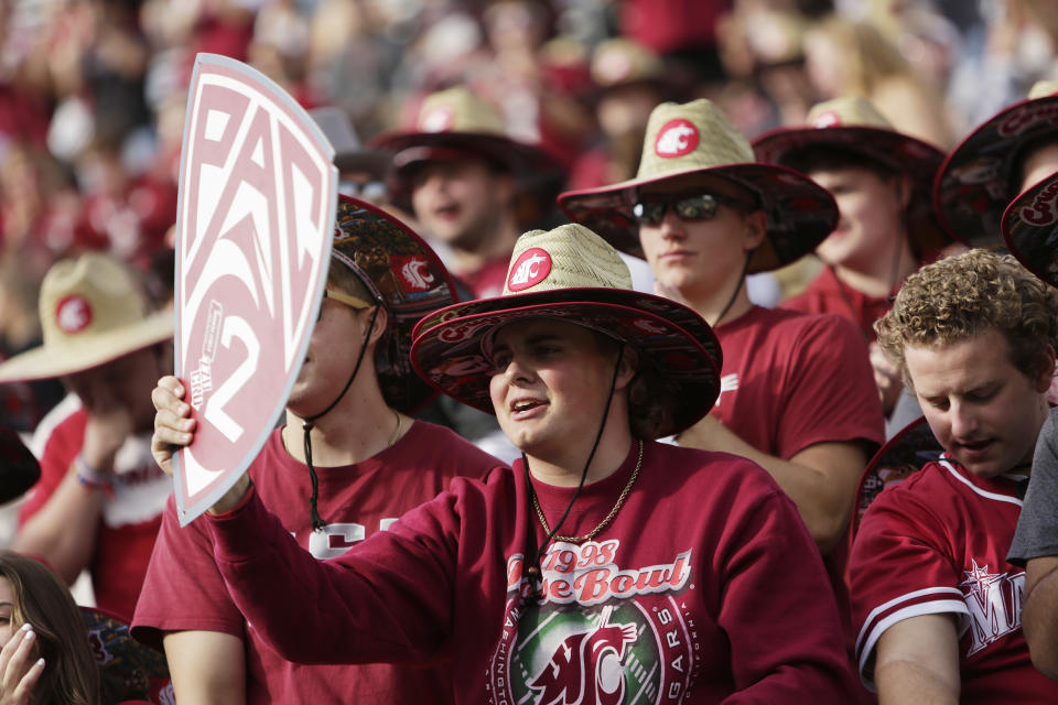 Washington State University student Michael Smith holds a "Pac-2" sign during warmups before an NCAA college football game between Washington State and Oregon State, Saturday, Sept. 23, 2023, in Pullman, Wash. The two schools are the only ones remaining in the Pac-12 after the 2023-2024 academic year after the other schools in the conference announced plans to leave (AP Photo/Young Kwak)