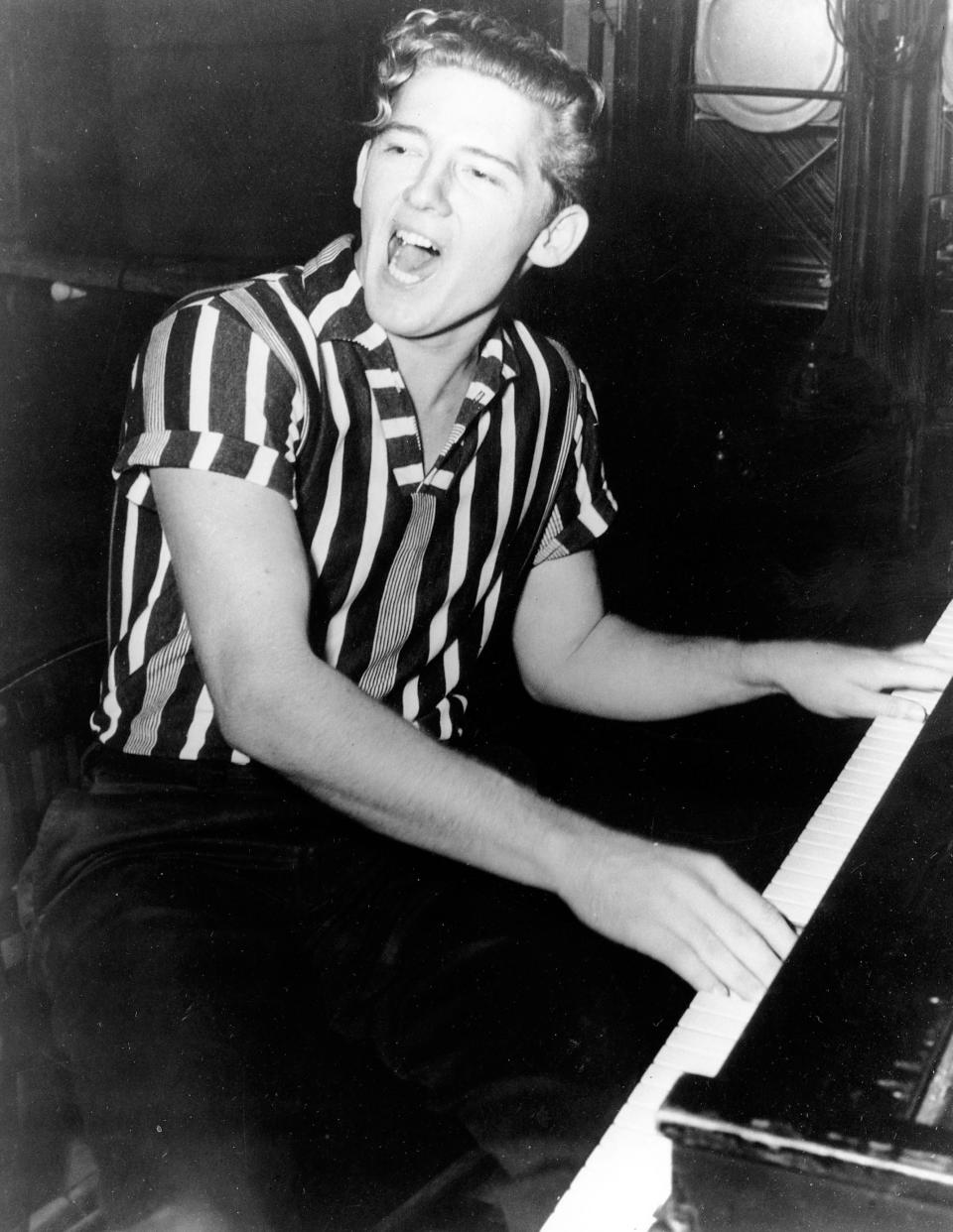 Rock 'n' roll musician Jerry Lee Lewis plays the piano in this 1957 photo.