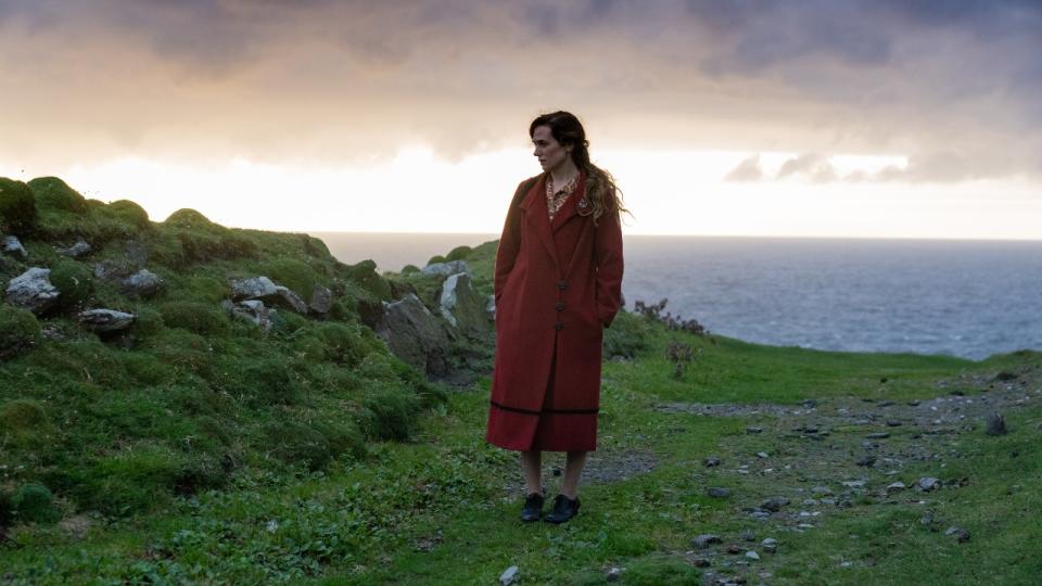 Kerry Condon standing in a red coat