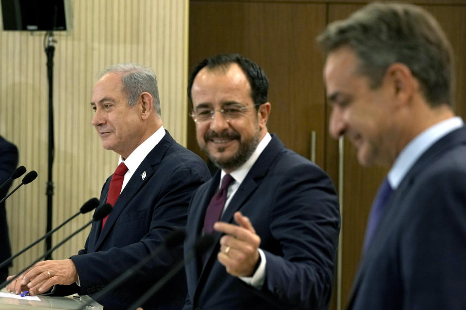 Cypriot President Nikos Christodoulides, center, Greek Prime Minister Kyriakos Mitsotakis, right, and Israeli Prime Minister Benjamin Netanyahu speak to the media, during a press conference at the presidential palace in capital Nicosia, Cyprus, on Monday, Sept. 4, 2023. Israel's prime minister is floating the idea of building infrastructure projects such as a fiber optic cable linking countries in Asia and the Arabian Peninsula with Europe through Israel and Cyprus. (AP Photo/Petros Karadjias, Pool)