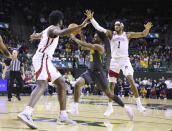 Baylor guard Adam Flagler (10) drives between Arkansas forward Makhi Mitchell (15) and guard Ricky Council IV (1) in the first half of an NCAA college basketball game, Saturday, Jan. 28, 2023, in Waco, Texas. (Rod Aydelotte/Waco Tribune-Herald via AP)