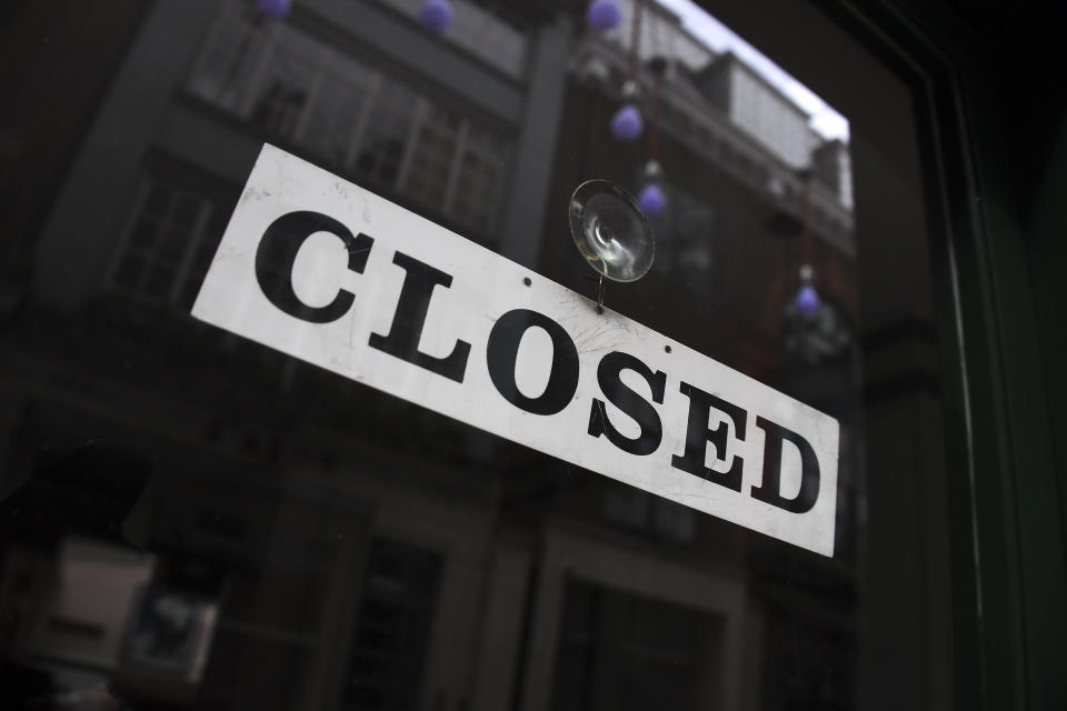 A closed sign is displayed in the door of a restaurant as the lockdown due to the coronavirus outbreak continues, in London, Thursday, April 30, 2020.(AP Photo/Alberto Pezzali)