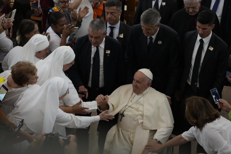 Pope Francis leaves the parish of Serafina at the end of a meeting with representatives of some aid and charity centers ahead of Sunday's 37th World Youth Day in Lisbon, Friday, Aug. 4, 2023. Francis is in Portugal through the weekend to preside over the jamboree that St. John Paul II launched in the 1980s to encourage young Catholics in their faith. The Argentine Jesuit has picked up John Paul's mantle with gusto as he seeks to inspire the next generation to rally behind his key social justice and environmental priorities.(AP Photo/Gregorio Borgia)