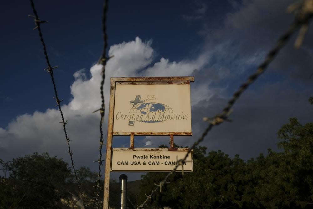 A custom sign stands outside Christian Aid Ministries in Titanyen, Haiti, Thursday, Oct. 21, 2021. The ministry posted a statement on its website Sunday, Nov. 21, reporting two of 17 members of the missionary group kidnapped Oct. 16 have been released.