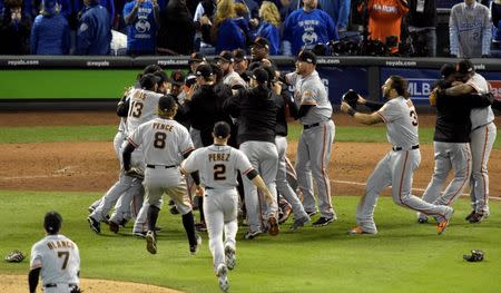 San Francisco Giants fans celebrate on the field after defeating the Kansas City Royals during game seven of the 2014 World Series at Kauffman Stadium. Christopher Hanewinckel-USA TODAY Sports