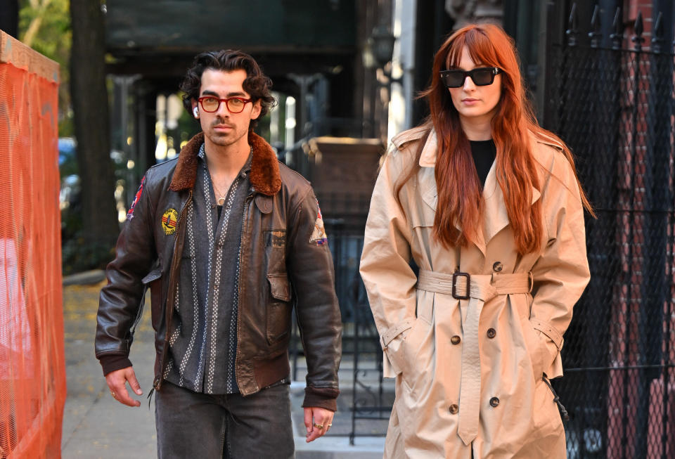 Close-up of Joe and Sophie walking on the street