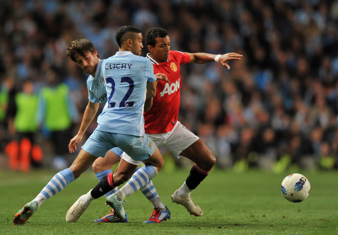 Manchester United's Portuguese midfielder Nani (R) vies for the ball against Manchester City's Spanish footballer David Silva (L) and Manchester City's French footballer Gael Clichy (C) during their English Premier League football match at The Etihad stadium in Manchester, north-west England on April 30, 2012. AFP PHOTO/PAUL ELLIS RESTRICTED TO EDITORIAL USE. No use with unauthorized audio, video, data, fixture lists, club/league logos or “live” services. Online in-match use limited to 45 images, no video emulation. No use in betting, games or single club/league/player publications.PAUL ELLIS/AFP/GettyImages