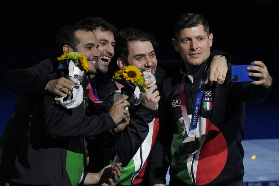 Italy Sabre team takes a selfie on the podium celebrating won the silver medal during the medal ceremony for the men's individual Sabre team final medal competition at the 2020 Summer Olympics, Wednesday, July 28, 2021, in Chiba, Japan. (AP Photo/Hassan Ammar)