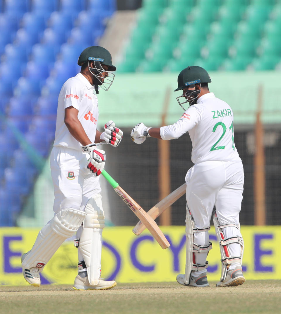 Bangladesh's Najmul Hossain Shanto, left, and Zakir Hasan celebrate scoring against India during the first Test cricket match on day four, in Chattogram Bangladesh, Saturday, Dec. 17, 2022. (AP Photo/Surjeet Yadav)