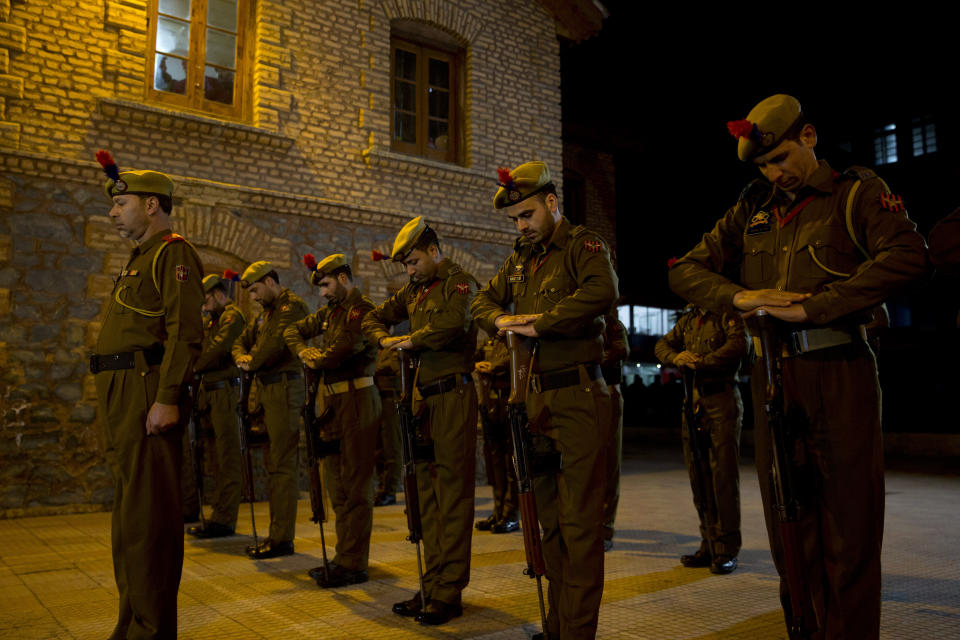 Indian policemen pay homage during a wreath-laying ceremony of their colleague in Srinagar, Indian controlled Kashmir, Monday, Feb. 18, 2019. Tensions escalated in the aftermath of a suicide attack in disputed Kashmir, with nine people killed Monday in a gunbattle that broke out as Indian soldiers scoured the area for militants.(AP Photo/ Dar Yasin)