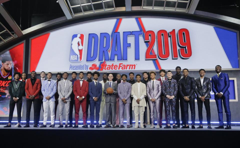 Prospective NBA draft picks pose for a group photo with NBA Commissioner Adam Silver, with basketball, before the NBA draft Thursday, June 20, 2019, in New York. (AP Photo/Julio Cortez)