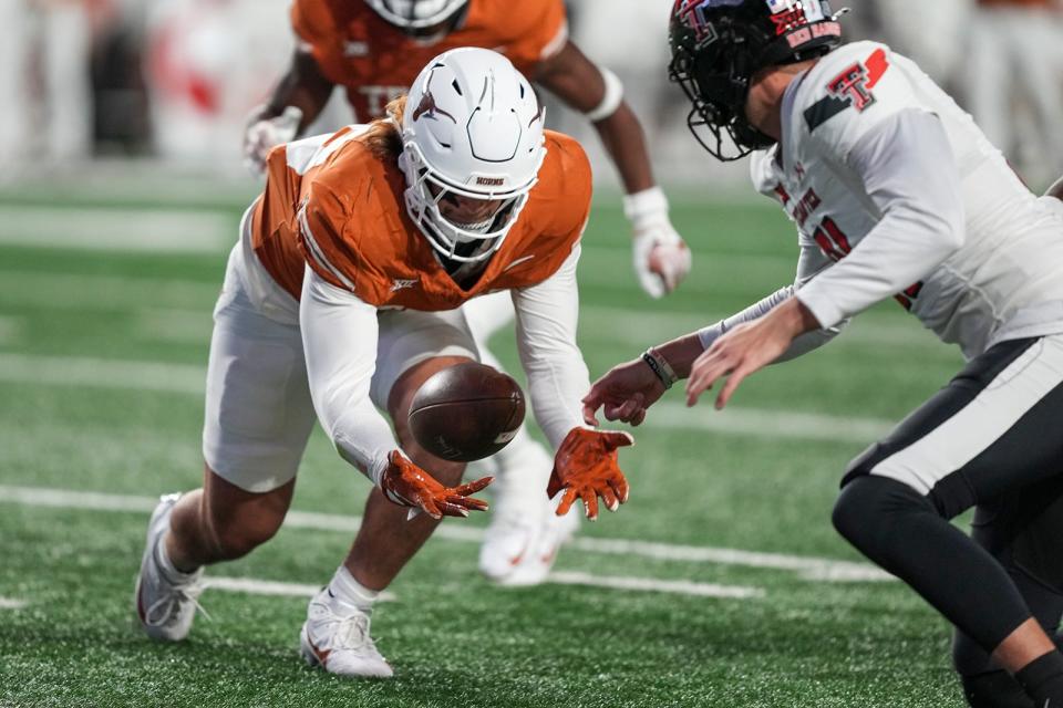 Texas Longhorns linebacker Liona Lefau tries to collect a loose ball against Texas Tech on Nov. 24. Lefau is part of an impressive freshman class, especially on the defensive side of the ball.