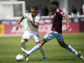 Los Angeles FC forward Cristian Arango, left, drives past Colorado Rapids defender Auston Trusty in the first half of an MLS soccer match Saturday, May 14, 2022, in Commerce City, Colo. (AP Photo/David Zalubowski)