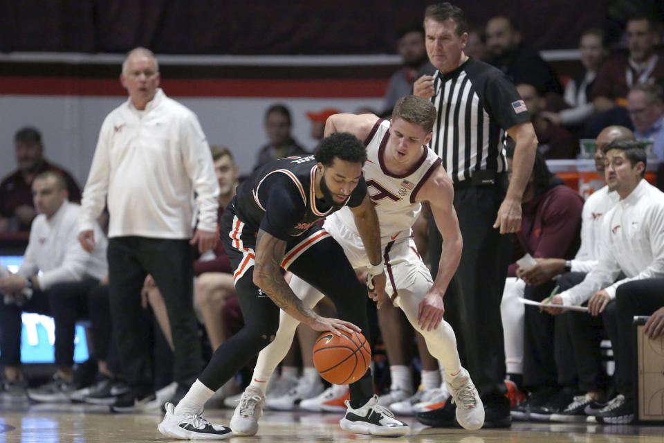 Campbell's Tasos Cook (1) is defended by Virginia Tech's Sean Pedulla (3) during the first half of an NCAA college basketball game Wednesday, Nov. 15, 2023, in Blacksburg, Va. (Matt Gentry/The Roanoke Times via AP)