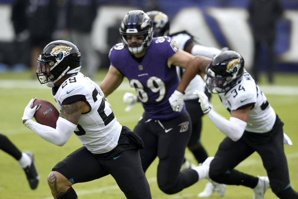 Jacksonville Jaguars safety Josh Jones, left, runs with the ball after intercepting a pass from Baltimore Ravens quarterback Lamar Jackson, not visible, prior to an NFL football game, Sunday, Dec. 20, 2020, in Baltimore. (AP Photo/Gail Burton)