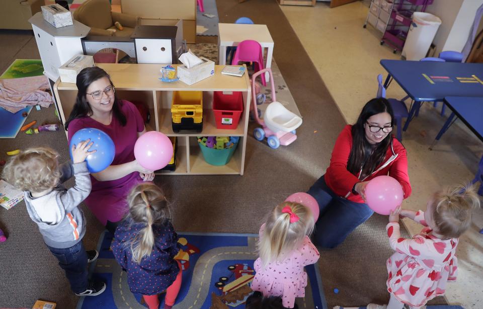 Lead teachers Aleesha Amador, left, Paola Berndt play a balloon game with children at Joyful Beginnings Academy, a new childcare center that recently opened in the former Kuddly Kids Child Care building in Dale.