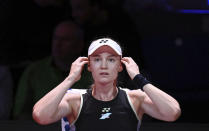 Kazakhstan's Elena Rybakina sits in her chair between games during the women's singles semifinal match against Poland's Iga Swiatek at the WTA Tour in Stuttgart, Germany, Saturday April 20, 2024. (Marijan Murat/dpa via AP)