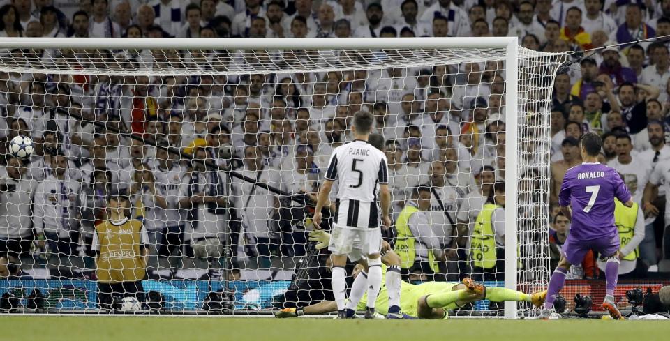 <p>Real Madrid’s Cristiano Ronaldo scores his side’s 3rd goal during the Champions League Final soccer match between Juventus and Real Madrid at the Millennium Stadium in Cardiff </p>