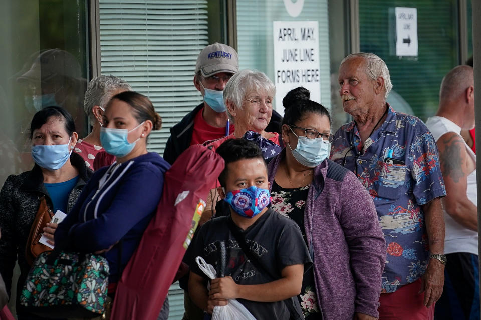 People line up outside a Kentucky Career Center hoping to find assistance with their unemployment claim in Frankfort, Kentucky, U.S. June 18, 2020. REUTERS/Bryan Woolston