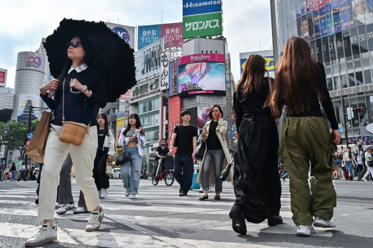 Pedestrians cross the intersection at Shibuya Crossing in Tokyo (Richard A. Brooks)