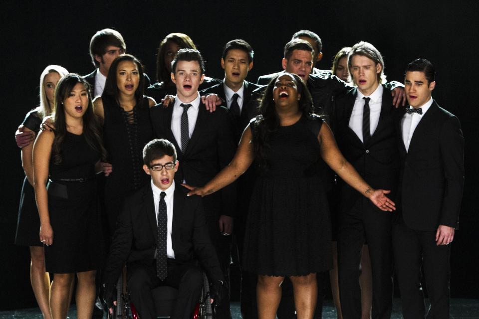 This photo released by Fox shows the McKinley family of the past and present joining together to remember and celebrate the life of Finn Hudson, paying tribute also to the late actor Cory Monteith who played him, in "The Quarterback" episode of "Glee," which aired Oct. 10, 2013. "Glee" hit the right note as it leads with eight nominations for the People's Choice Awards. Broadcast on CBS, The People's Choice Awards will be presented Wednesday, Jan. 8, 2014. (AP Photo/Fox, Adam Rose)