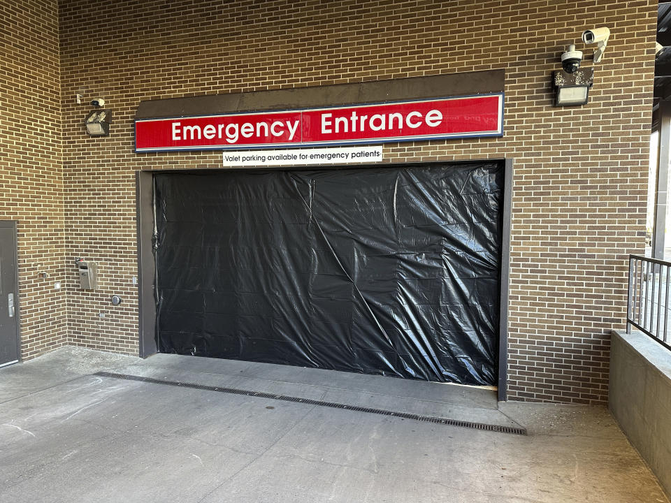 This photo shows where the main entrance of the Sanford Health Emergency Department's vehicle and ambulance garage sustained damage Wednesday in connection with Ian Cramer driving away from the hospital in Bismarck, N.D., Thursday, Dec. 7, 2023. Cramer, the son of Republican U.S. Sen. Kevin Cramer of North Dakota, is in jail after allegedly crashing into a Mercer County sheriff's vehicle near Hazen and killing Deputy Paul Martin, 53. No one was injured at the hospital, according to Sanford Health Bismarck. (AP Photo/Jack Dura)