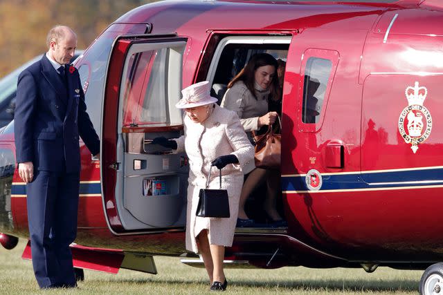 <p>Max Mumby/Indigo/Getty Images</p> Queen Elizabeth (center) and Samantha Cohen exit a helicopter to attend a statue unveiling in Newmarket in November 2016