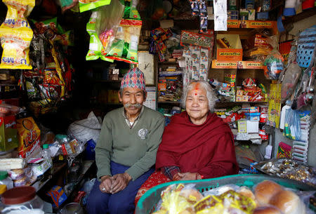 Nhuchhe Bahadur Amatya, 76, a retired accountant at Nepal Electricity Authority along with his wife Raywoti Devi Amatya, 74, a housewife, pose for a picture as they sit inside their shop in Lalitpur, Nepal, February 4, 2018. Nhuchhe was 17 and Raywoti was 15 when they had their arranged marriage 59 years ago. "I saw Raywoti for the first time at my home after we officially got married, during the wedding her face was covered with a Ghumto (veil)," said Nchuchhe. REUTERS/Navesh Chitrakar