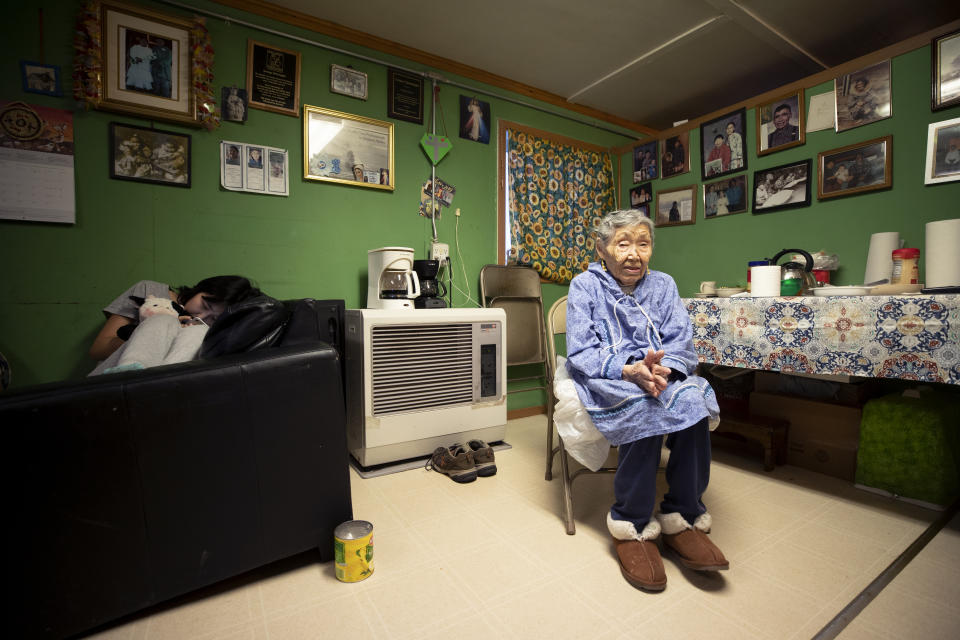 In this Monday, Jan. 20, 2020 image, Lizzie Chimiugak, right, looks on at her home in Toksook Bay, Alaska. Chimiugak, who turned 90 years old on Monday, is scheduled to be the first person counted in the 2020 U.S. Census on Tuesday. (AP Photo/Gregory Bull)