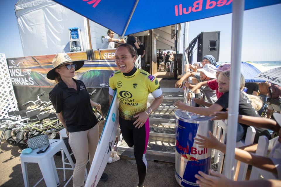 Carissa Moore of Hawaii is cheered on by young fans as she heads out of her locker room to compete