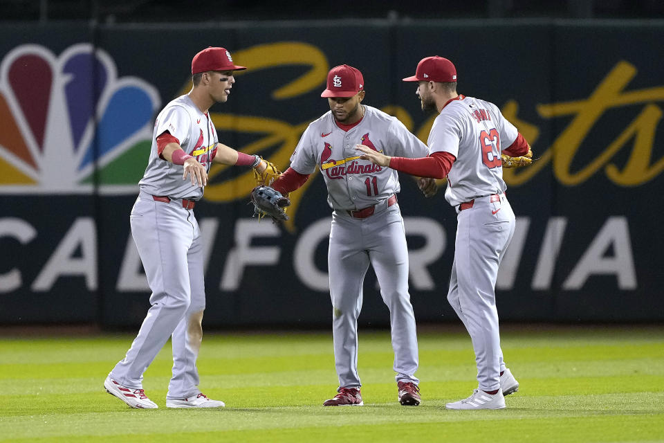 St. Louis Cardinals' Lars Nootbaar, left, Victor Scott II (11) and Michael Siani celebrate the team's win over the Oakland Athletics in a baseball game in Oakland, Calif., Tuesday, April 16, 2024. (AP Photo/Tony Avelar)