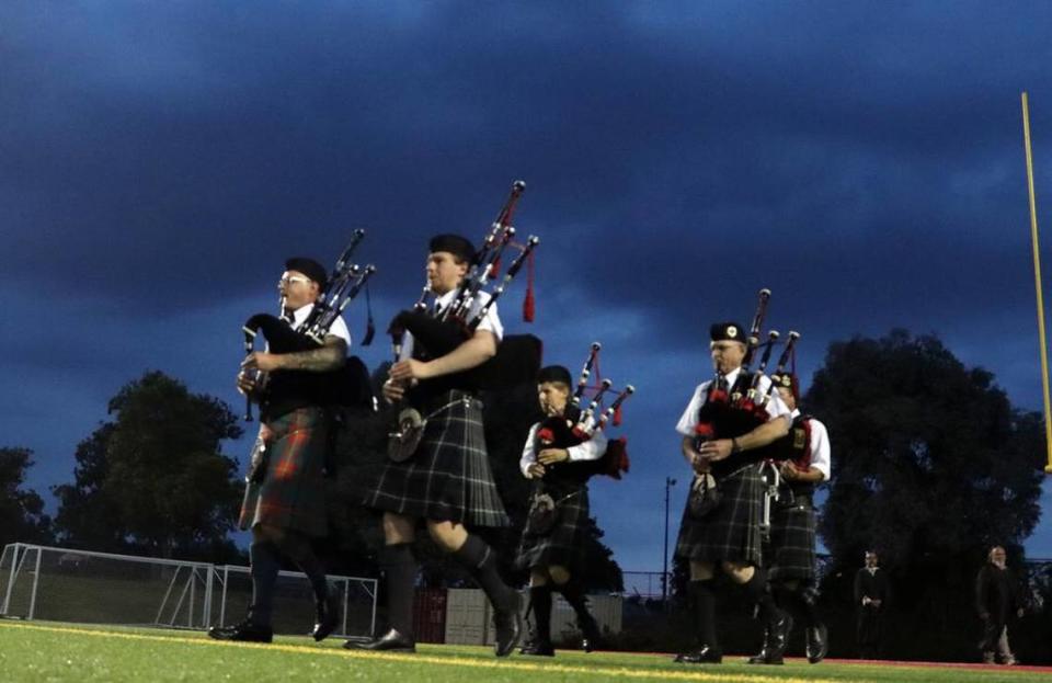 The Fresno Stag and Thistle Pipes and Drums march into the stadium during the McLane High graduation on June 6, 2023.