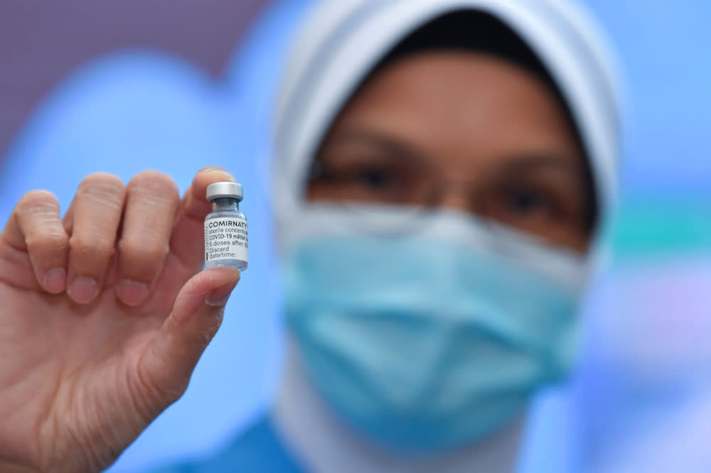 Chief Nurse Lina Ibrahim shows the Pfizer BioNTech Covid-19 vaccine at Putrajaya District Health Office Precinct 1, February 24, 2021. — Bernama pic