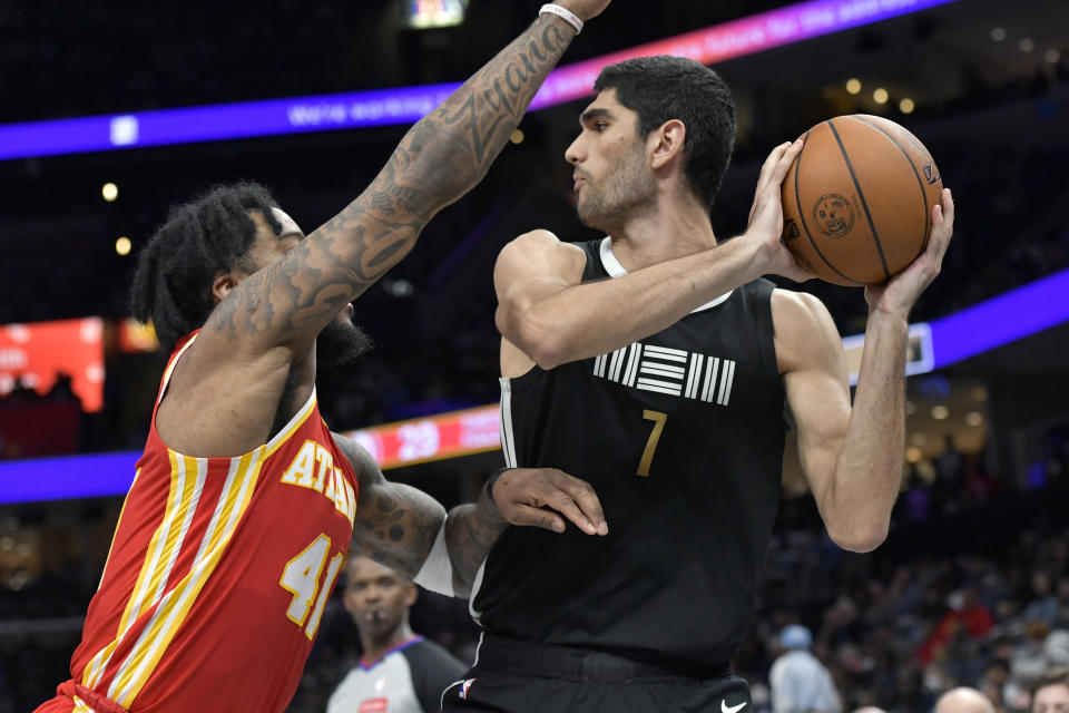 Memphis Grizzlies forward Santi Aldama (7) keeps the ball from Atlanta Hawks forward Saddiq Bey (41) during the first half of an NBA basketball game Friday, March 8, 2024, in Memphis, Tenn. (AP Photo/Brandon Dill)