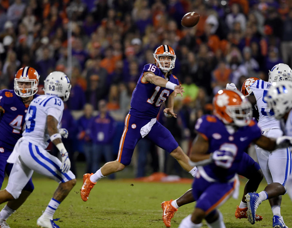 FILE - In this Nov. 17, 2018, file photo, Clemson quarterback Trevor Lawrence throws a pass under pressure during the first half of an NCAA college football game against Duke, in Clemson, S.C. For the first time, the defending national champion Tigers are No. 1 in The Associated Press preseason Top 25 presented by Regions Bank, Monday, Aug. 19, 2019. Clemson won its second national title in three seasons behind freshman quarterback Trevor Lawrence to claim equal standing with Alabama at the top of the sport. (AP Photo/Richard Shiro, File)