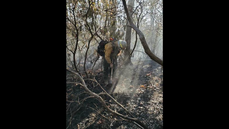 A firefighter tackles part of a 434-acre, 3-week-old brush fire in Henderson County, NC.