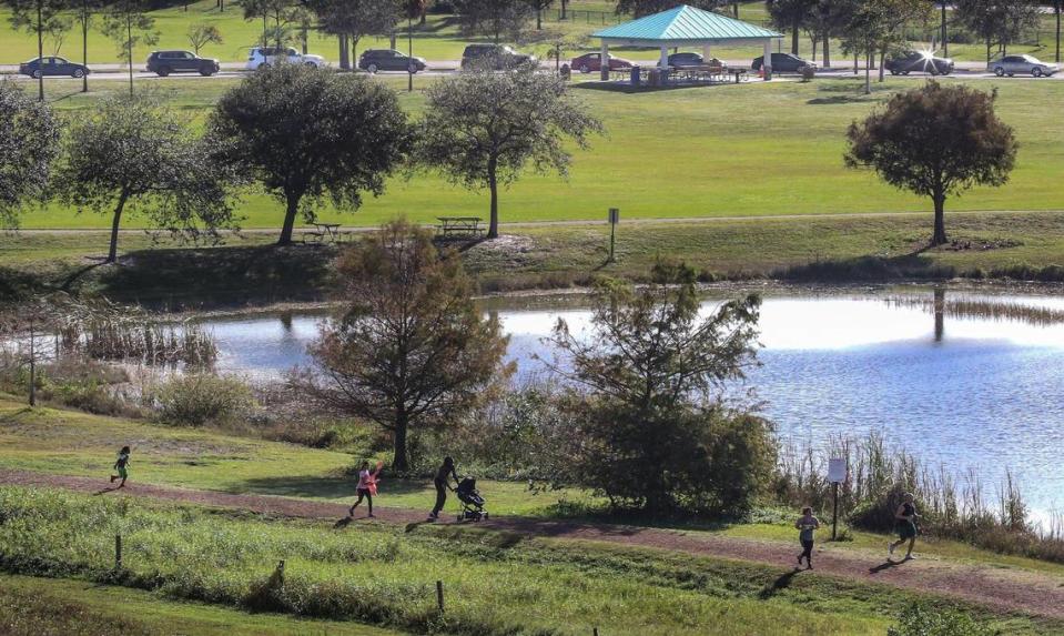 On Sunday, January 3, 2021 motorists line-up for COVID-19 vaccination shots for people who are 65 and older as site staffers assist at Vista View Park in Davie, Florida.