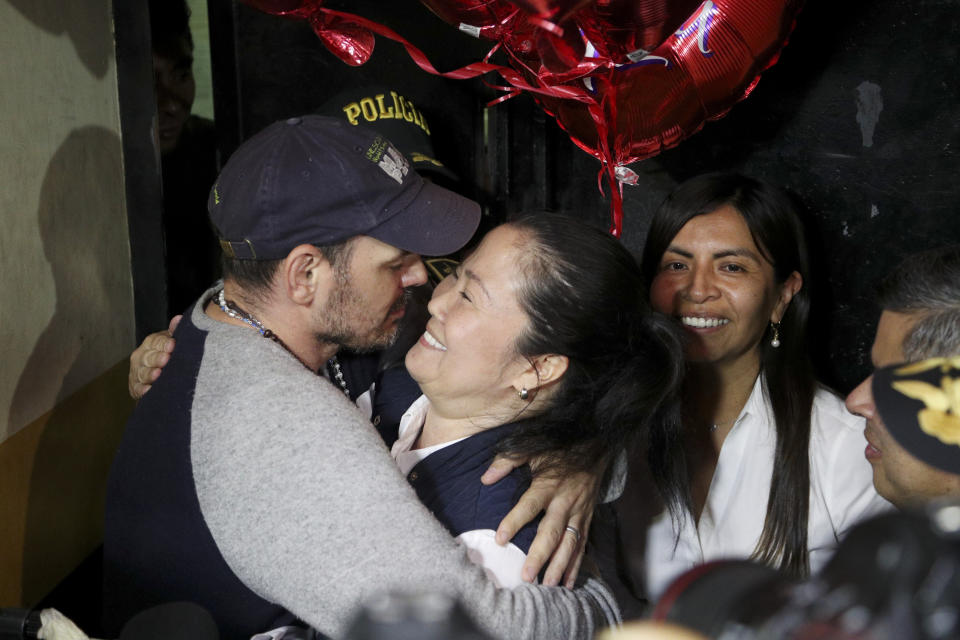 Keiko Fujimori, right, is embraced by her husband Mark Vito Villanela after she was released from Santa Mónica women's prison in Lima, Peru, Friday, Nov. 29, 2019. The Constitutional Tribunal narrowly approved a habeas corpus request to free Fujimori from detention while she is investigated for alleged accusations she accepted money from Brazilian construction giant Odebrecht.(AP Photo/Martin Mejia)