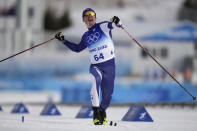 Iivo Niskanen, of Finland, celebrates as he crosses the finish line during the men's 15km classic cross-country skiing competition at the 2022 Winter Olympics, Friday, Feb. 11, 2022, in Zhangjiakou, China. (AP Photo/Alessandra Tarantino)