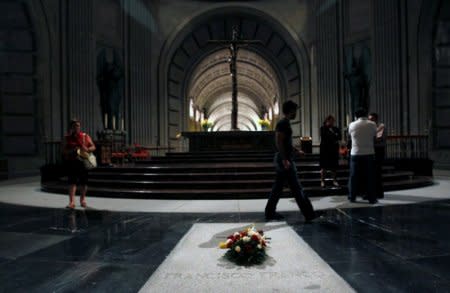 FILE PHOTO: Visitors walk past the tomb of dictator Francisco Franco at  El Valle de los Caidos (The Valley of the Fallen), the giant mausoleum holding the remains of Franco, in San Lorenzo de El Escorial, outside Madrid July 12, 2011.   REUTERS/Andrea Comas/File Photo