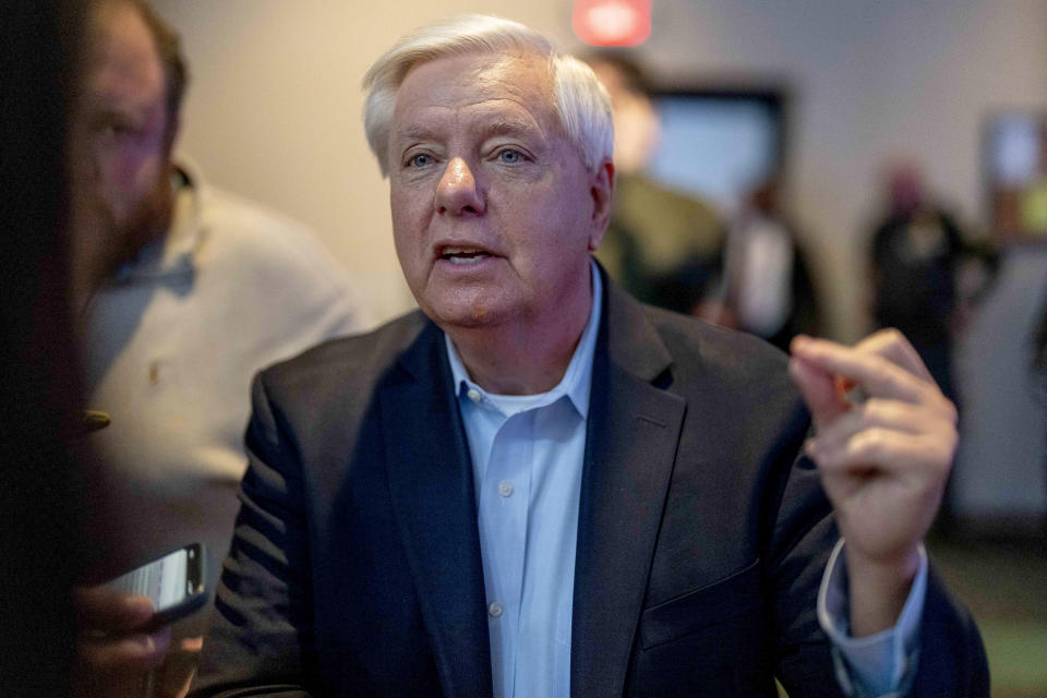 FILE - Sen. Lindsey Graham, R-S.C., speaks to members of the media at a primary election night party for Republican presidential candidate former President Donald Trump at the South Carolina State Fairgrounds in Columbia, S.C., Saturday, Feb. 24, 2024. The arrest of a Venezuelan man who entered the U.S. illegally for the murder of a 22-year-old nursing student in Georgia has triggered fiery reactions from Donald Trump and his allies. Trump blamed President Joe Biden and his immigration policies for the fatal beating of 22-year-old Laken Riley while on her morning run. Graham, a Trump ally, predicted Riley's death is "gonna change this election as much as anything." (AP Photo/Andrew Harnik)