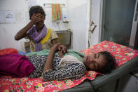 <p>Kajal Nur, 11, is treated for injuries from a road traffic accident as her friend tries to comfort her at the ‘Doctors Without Borders’ Kutupalong clinic on October 4, 2017 in Cox’s Bazar, Bangladesh. (Photograph by Paula Bronstein/Getty Images) </p>