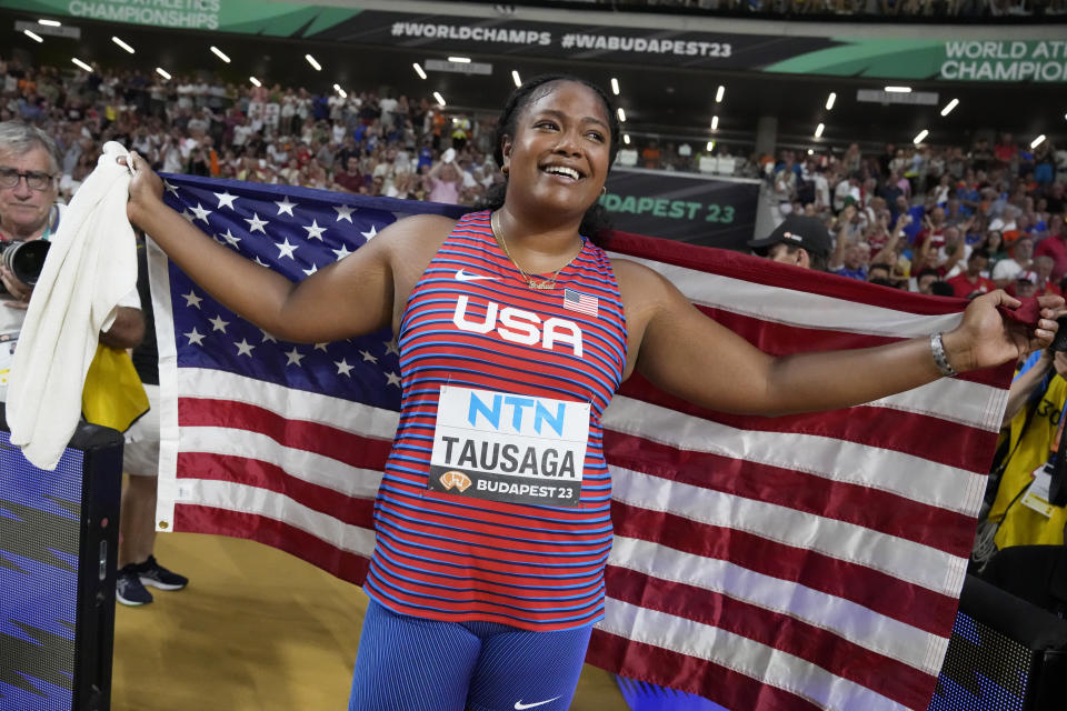 Laulauga Tausaga, of the United States, smiles after winning the gold medal in the Women's discus throw final during the World Athletics Championships in Budapest, Hungary, Tuesday, Aug. 22, 2023. (AP Photo/Matthias Schrader)