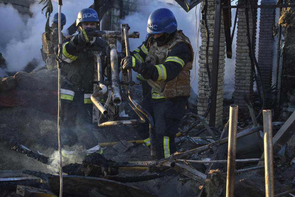 Members of the Ukrainian State Emergency Service clear the rubble at the building which was destroyed as a result of Russian strike in Zaporizhzhia district, Ukraine, Friday, March 31, 2023. (AP Photo/Andriy Andriyenko)