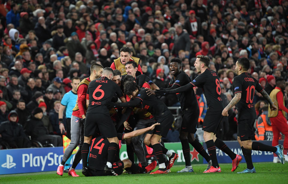 Atletico Madrid players celebrate the second Marcos Llorente goal at Anfield in their stunning upset of Liverpool. (Photo by Michael Regan - UEFA/UEFA via Getty Images)