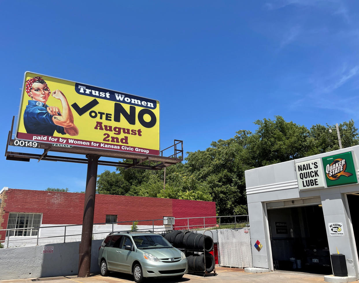 A billboard urging Kansans to vote reads: Trust women. Vote no Aug. 2nd. 