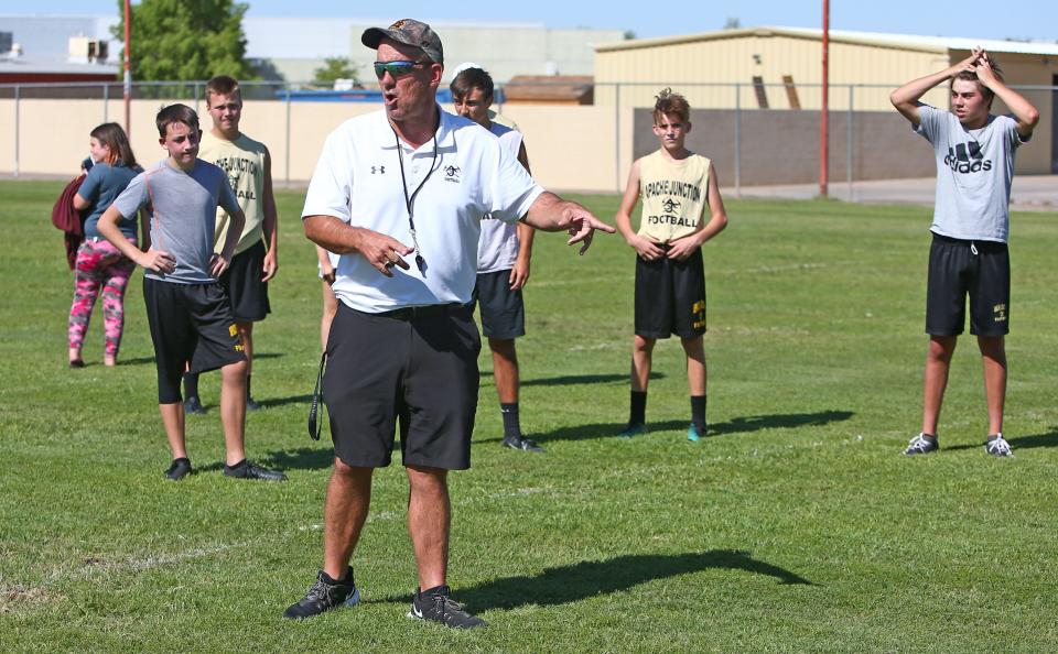 Apache Junction High School football head coach Bruce Binkley speaks to his players during practice in Apache Junction, Ariz. on June 11, 2020.